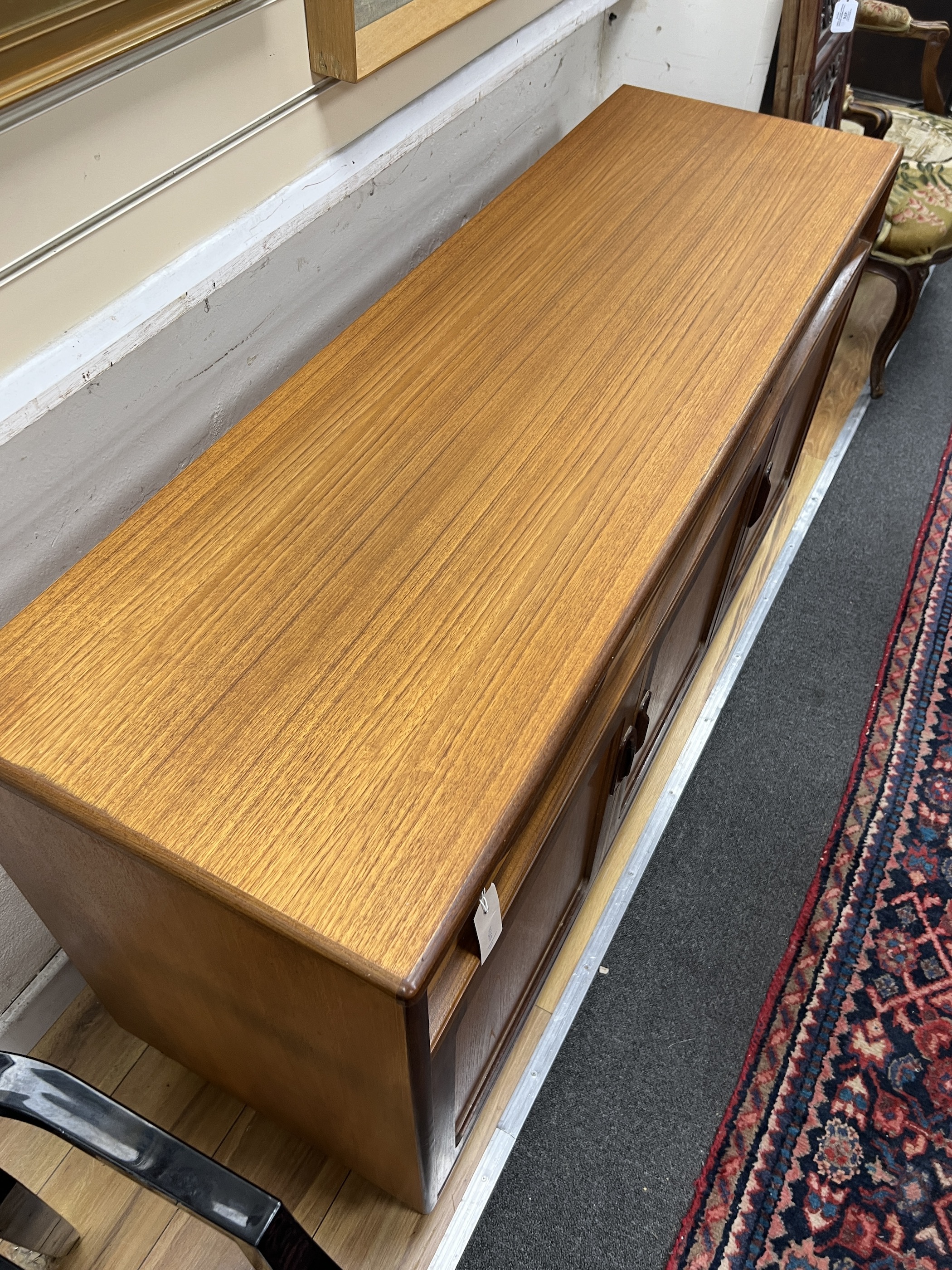 A mid century G Plan teak sideboard, length 142cm, depth 44cm, height 76cm